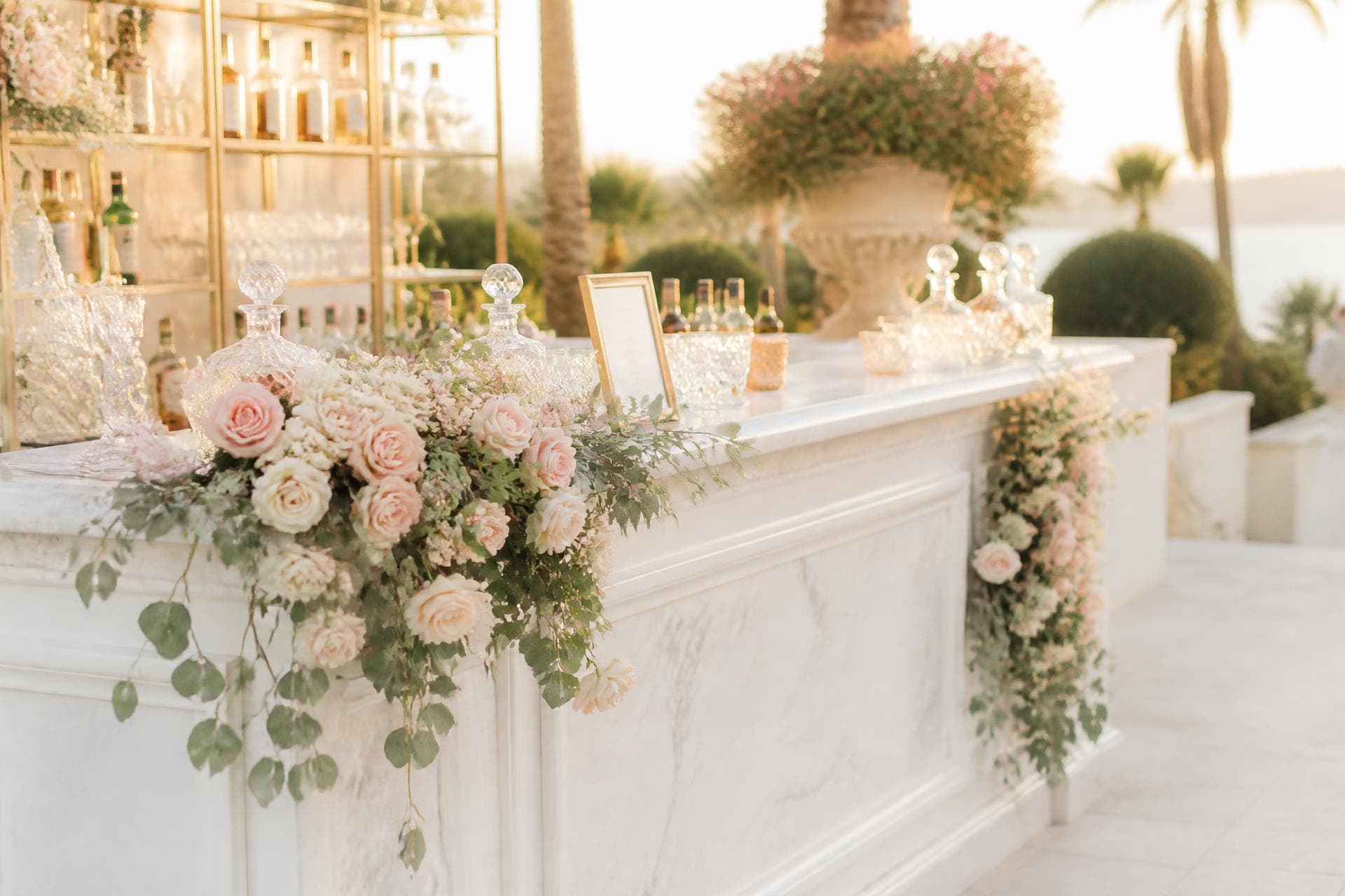 Luxury floral wedding bar set at golden hour